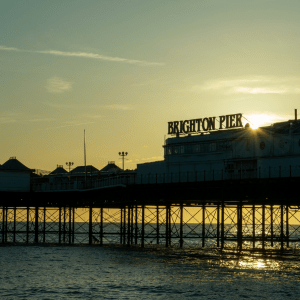 Photograph of Brighton Pier framed by the sea